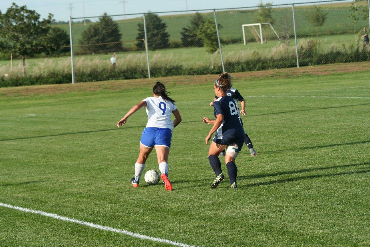 Sophomore Tessa Calabria takes on two defenders as she scores 4 goals and 3 assists in today's match.